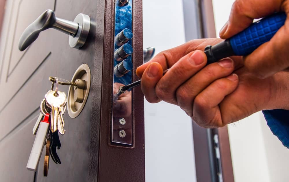 Technician extracting a broken key from a house door lock