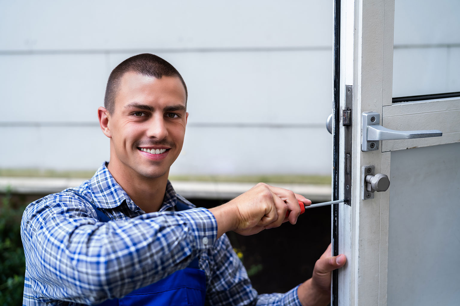Homeowner using a smart lock on their front door